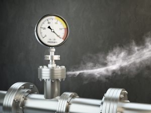 Gas leaking from industrial pressure gauge